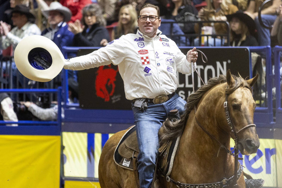 Coleman Proctor takes a victory lap after winning the team roping event during day nine of the ...