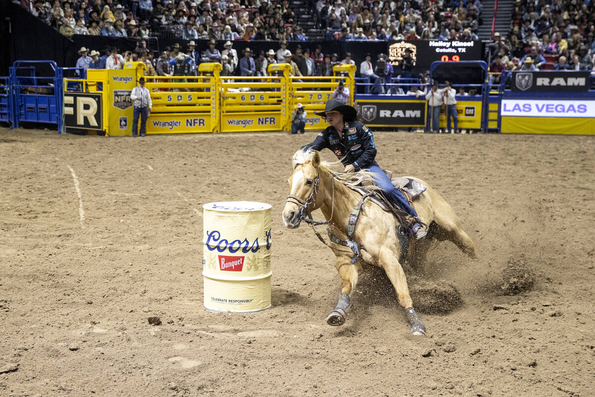 Hailey Kinsel rounds a barrel in the barrel racing event during day nine of the National Finals ...