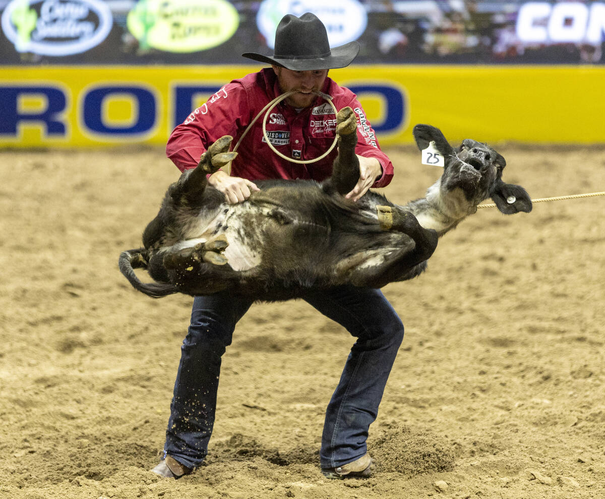 Joel Harris flips a calf in the tie-down roping event during day nine of the National Finals Ro ...