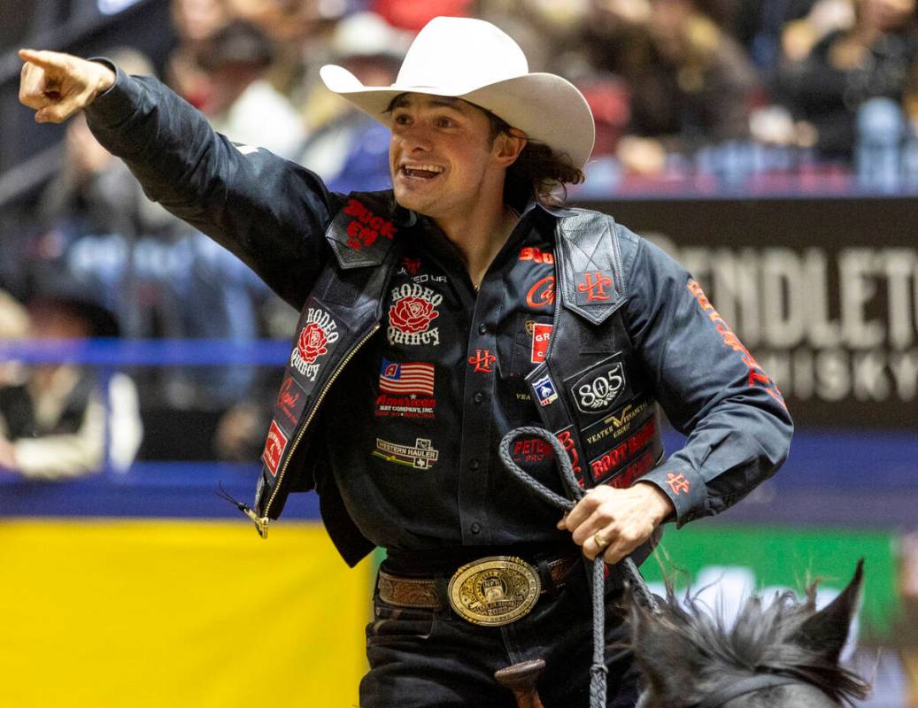 Lefty Holman takes a victory lap after winning the saddle bronc riding event during day nine of ...