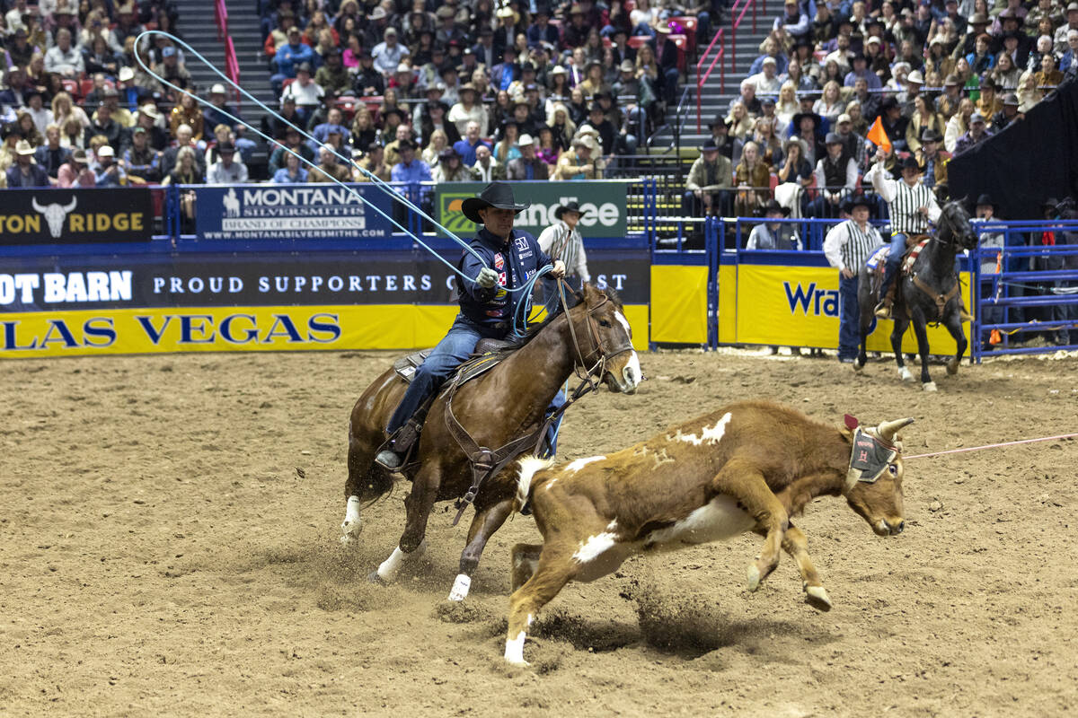 Logan Medlin throws his rope at a calf in the team roping event during day nine of the National ...