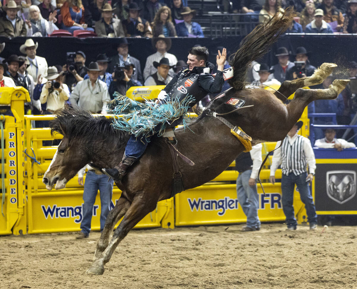 Jess Pope competes in the bareback riding event during day nine of the National Finals Rodeo at ...