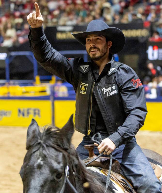 Tyler Bingham takes a victory lap after winning the bull riding event during day nine of the Na ...