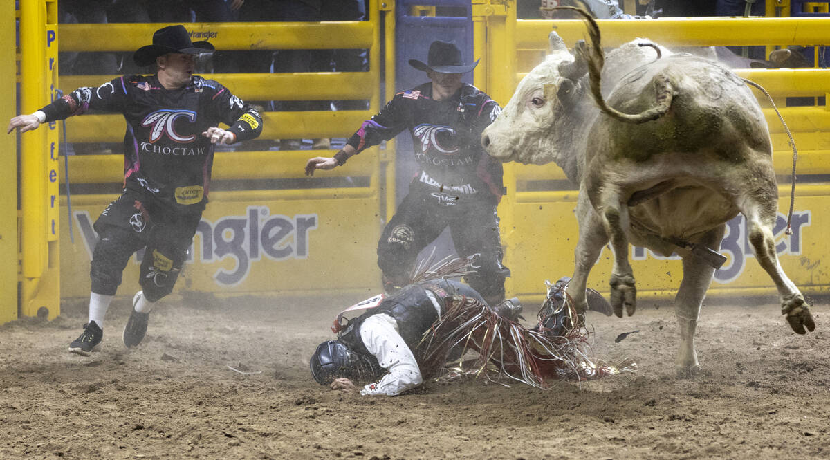 Cooper James falls off of Alberta Prime Devil’s Advocate in the bull riding event during ...