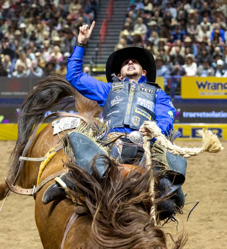 Statler Wright competes in the saddle bronc riding event during day nine of the National Finals ...