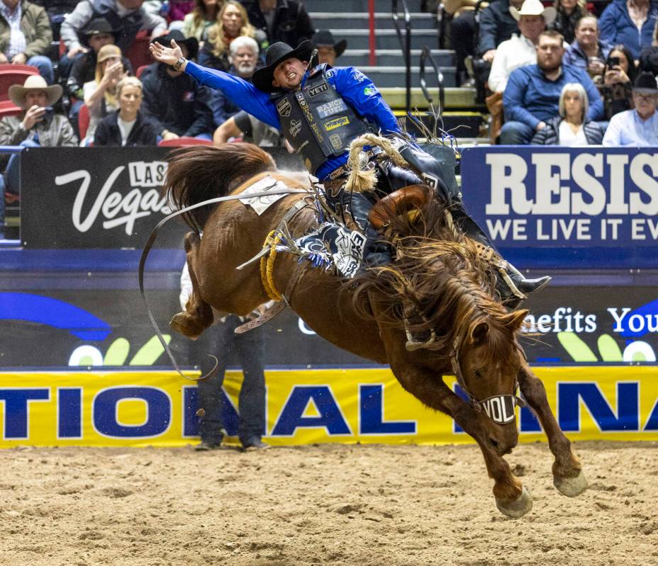 Statler Wright competes in the saddle bronc riding event during day nine of the National Finals ...