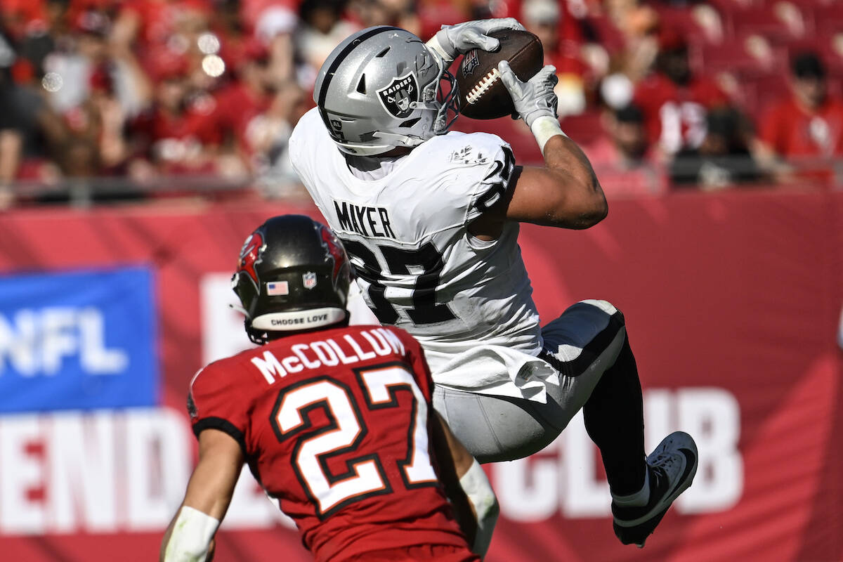 Las Vegas Raiders tight end Michael Mayer (87) makes a catch ahead of Tampa Bay Buccaneers corn ...