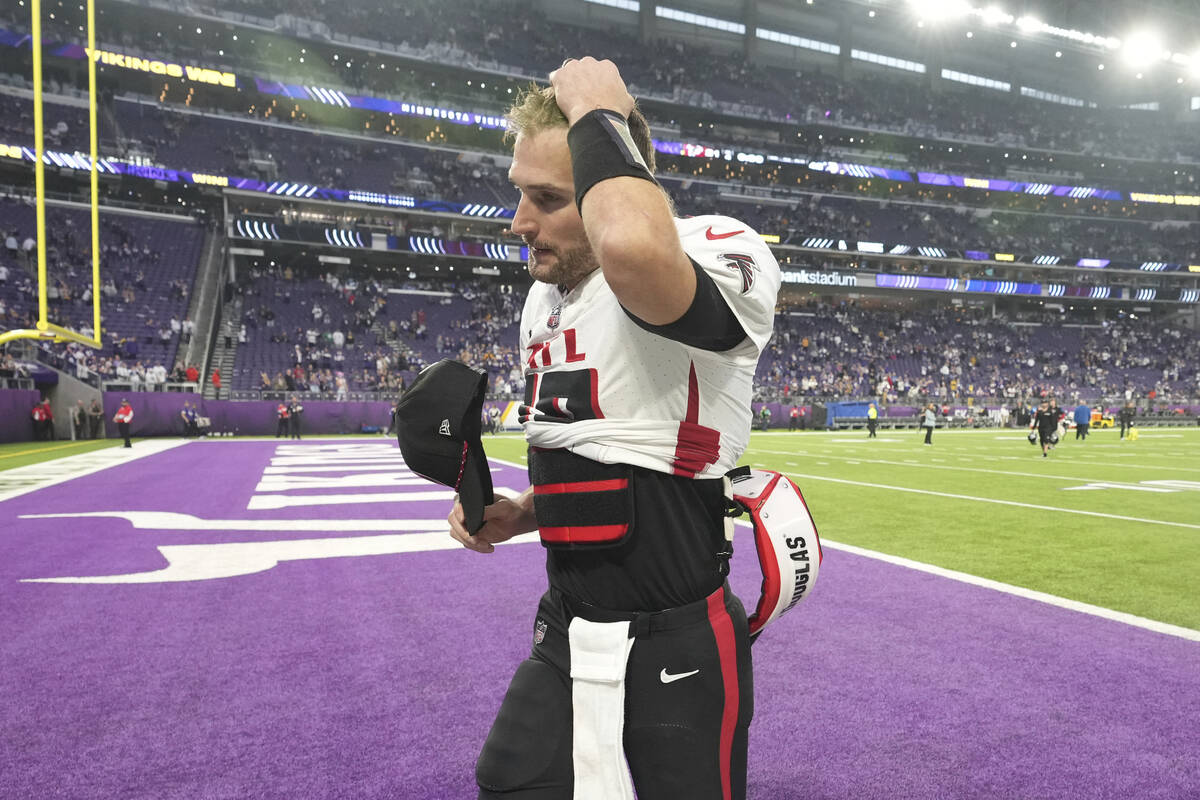 Atlanta Falcons quarterback Kirk Cousins (18) walks off the field after an NFL football game ag ...