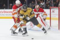 Golden Knights right wing Keegan Kolesar (55) moves the puck under pressure from Calgary Flames ...