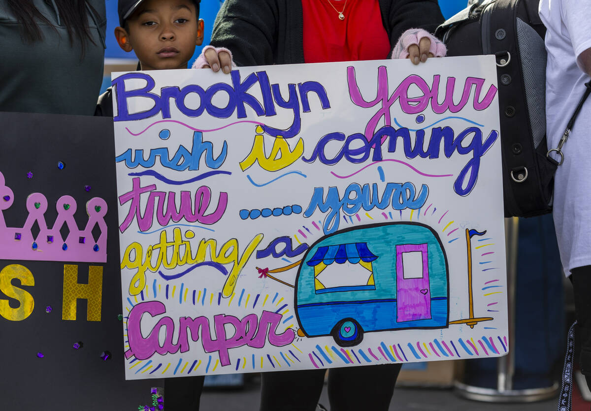 One off many signs are held for Brooklyn King, 2, and her family of Henderson for receiving a n ...