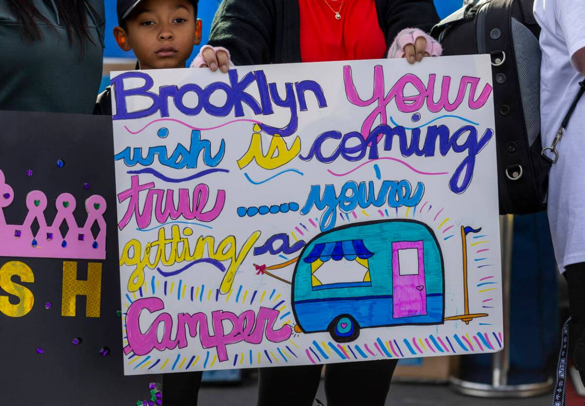 One off many signs are held for Brooklyn King, 2, and her family of Henderson for receiving a n ...