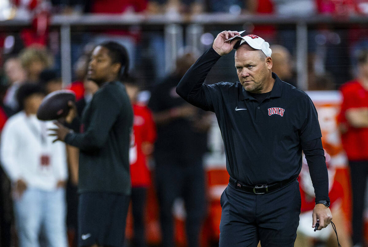 UNLV head coach Barry Odom watches his players during warmups of their NCAA football game again ...