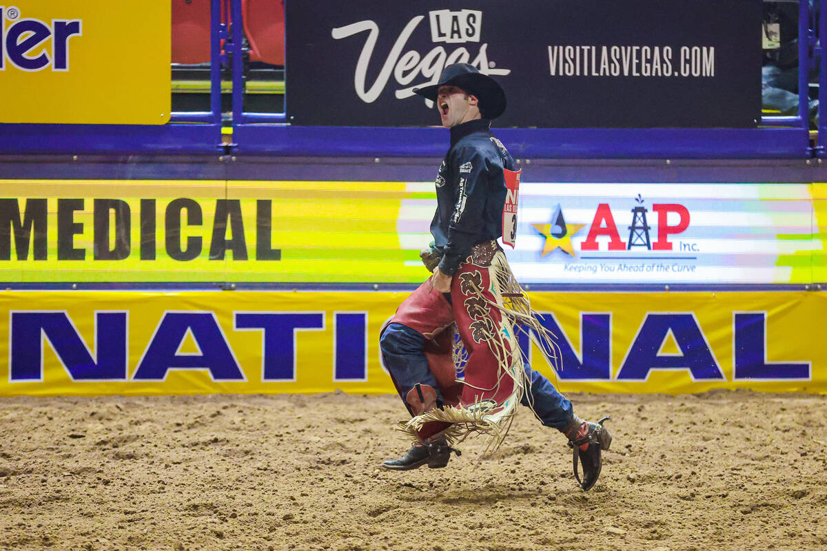 Bareback rider Leighton Berry celebrates his ride during the final night of National Finals Rod ...