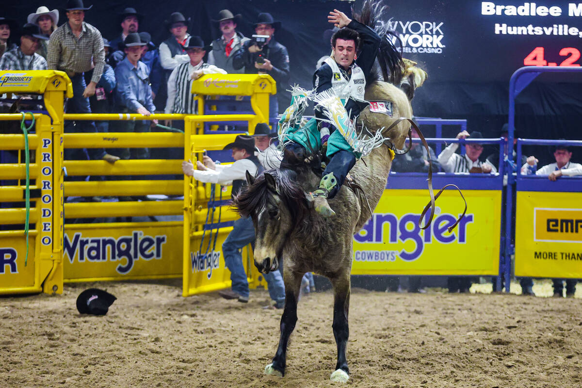 Bareback rider Bradlee Miller sticks on Straight Ringer during the final night of National Fina ...