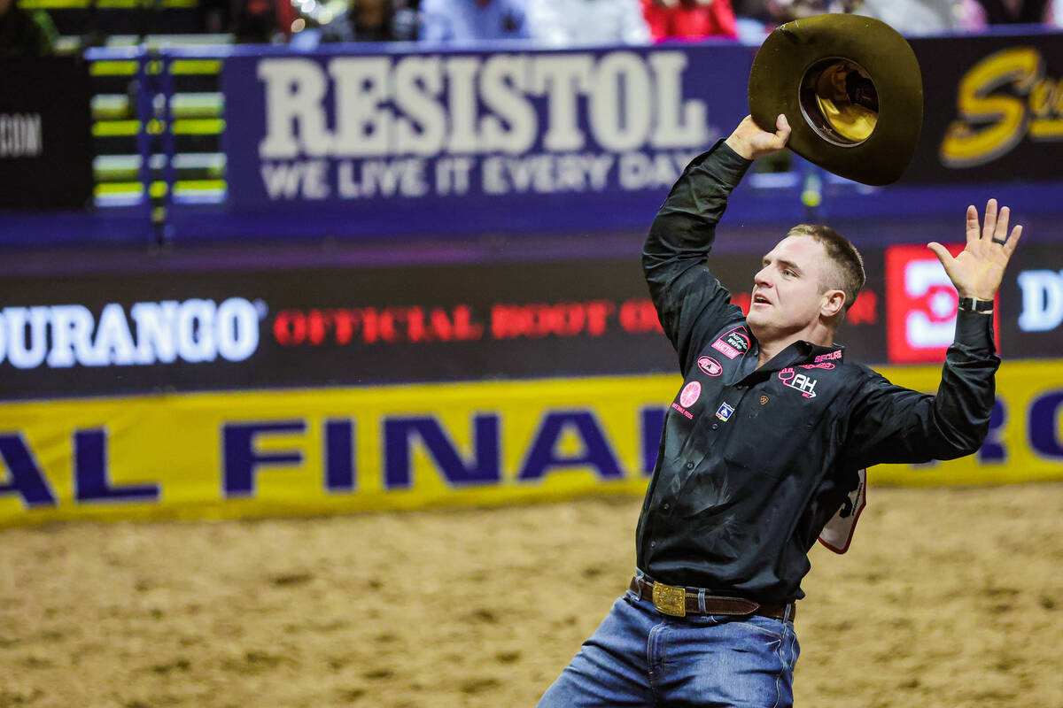 Steer wrestler J.D. Struxness celebrates during the final night of National Finals Rodeo at the ...