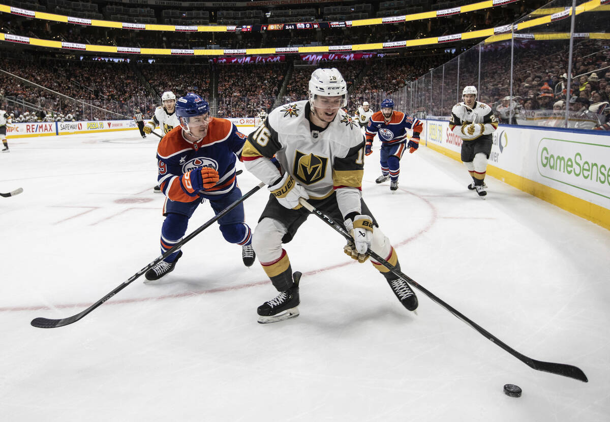 Vegas Golden Knights' Pavel Dorofeyev (16) and Edmonton Oilers' Ty Emberson (49) battle for the ...