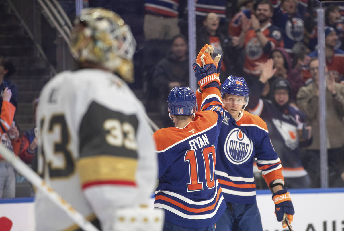 Vegas Golden Knights goalie Adin Hill (33) looks on as Edmonton Oilers' Derek Ryan (10) and Cor ...