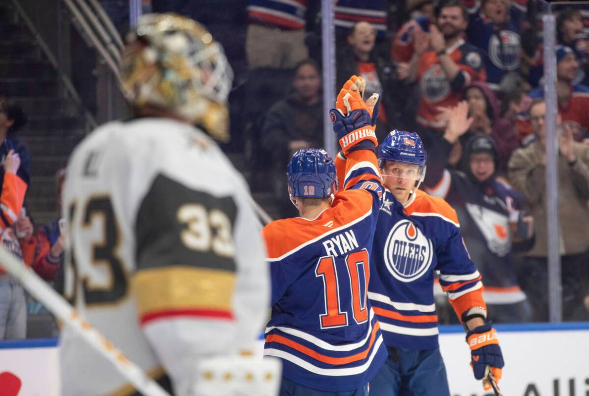 Vegas Golden Knights goalie Adin Hill (33) looks on as Edmonton Oilers' Derek Ryan (10) and Cor ...