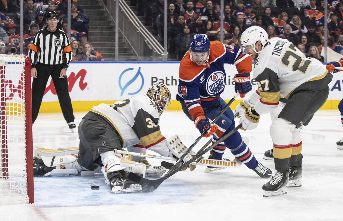 Vegas Golden Knights goalie Adin Hill (33) is scored on by Edmonton Oilers' Zach Hyman (18) and ...