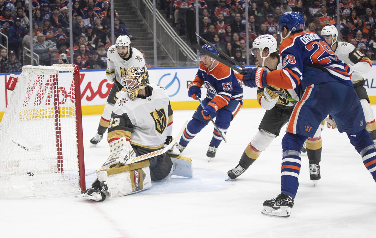 Vegas Golden Knights goalie Adin Hill (33) is scored on by Edmonton Oilers' Leon Draisaitl (29) ...