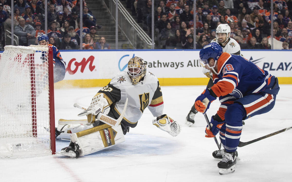 Vegas Golden Knights goalie Adin Hill (33) is scored on by Edmonton Oilers' Connor Brown (28) d ...