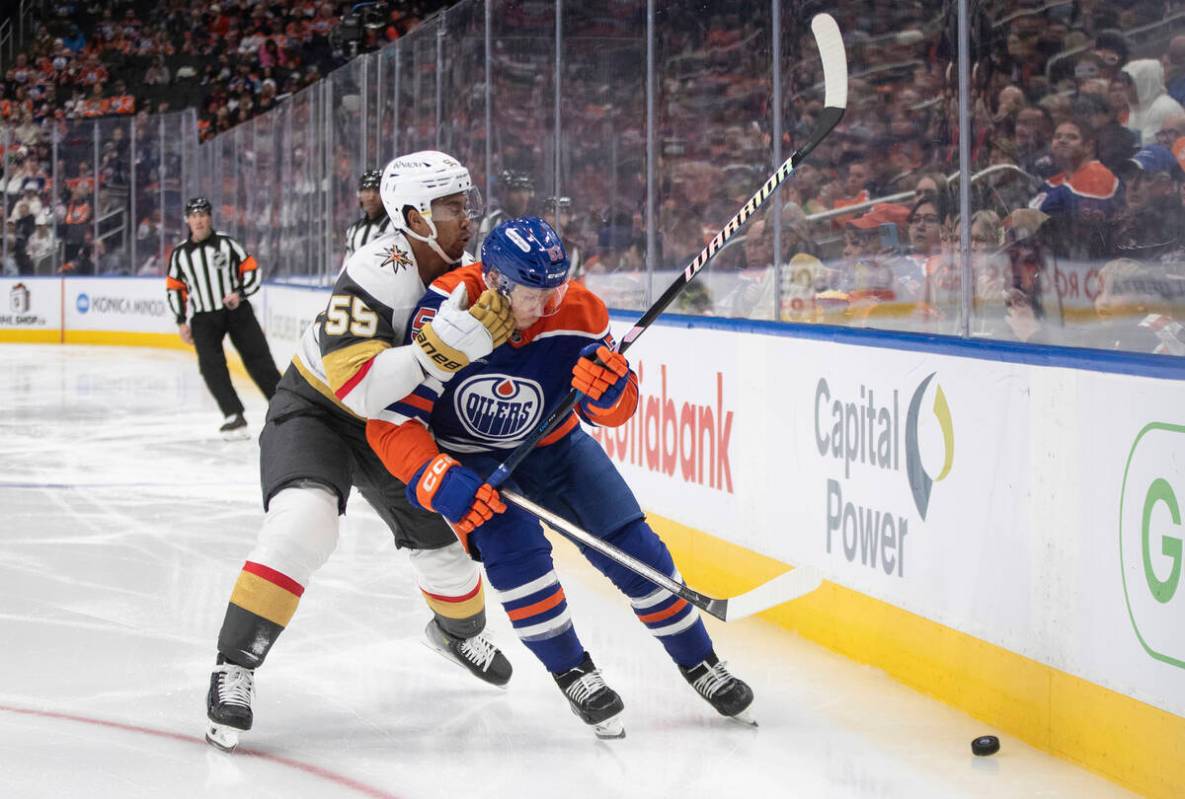 Vegas Golden Knights' Keegan Kolesar (55) and Edmonton Oilers' Jeff Skinner (53) battle for the ...