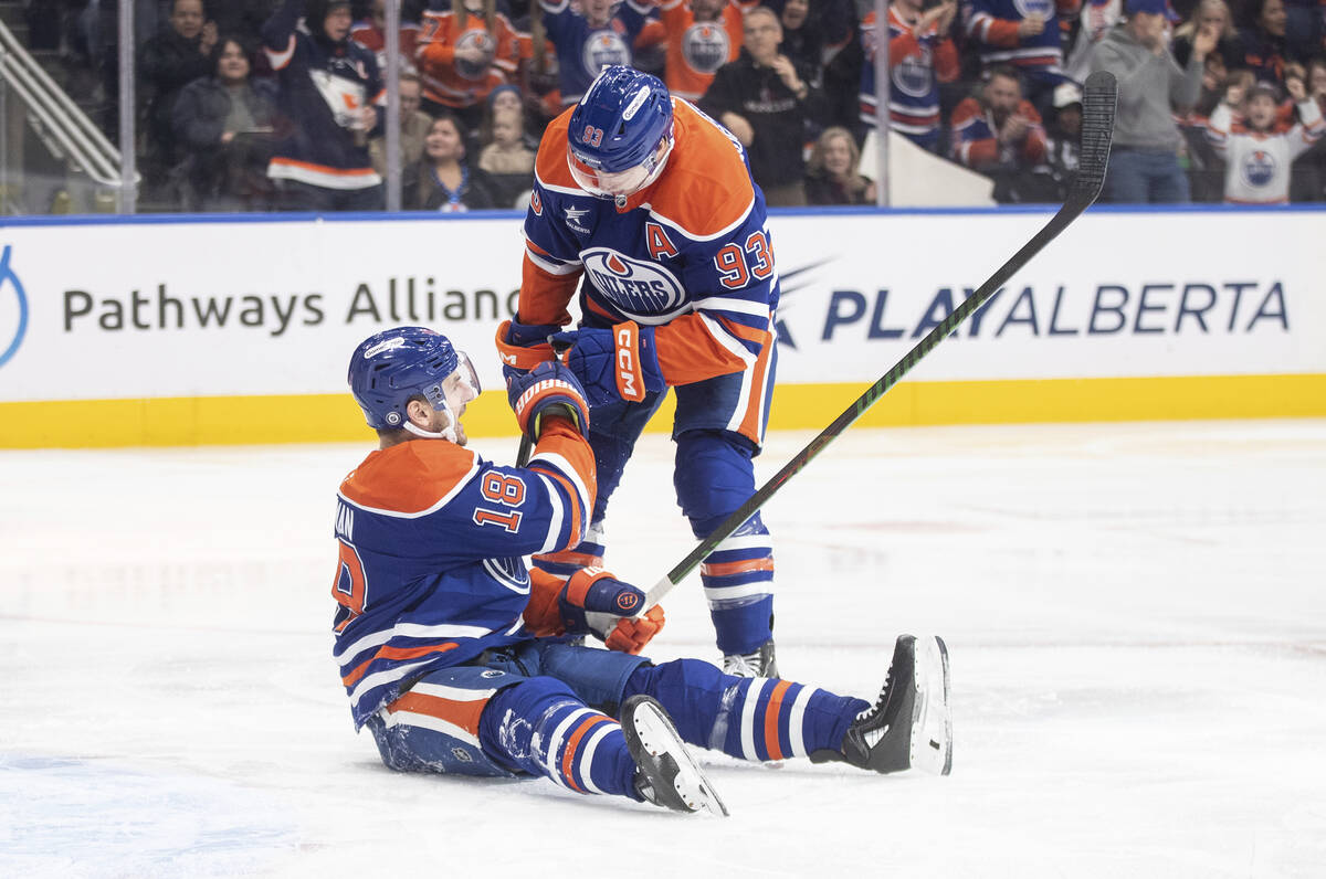 Edmonton Oilers' Zach Hyman (18) and Ryan Nugent-Hopkins (93) celebrate a goal against the Vega ...