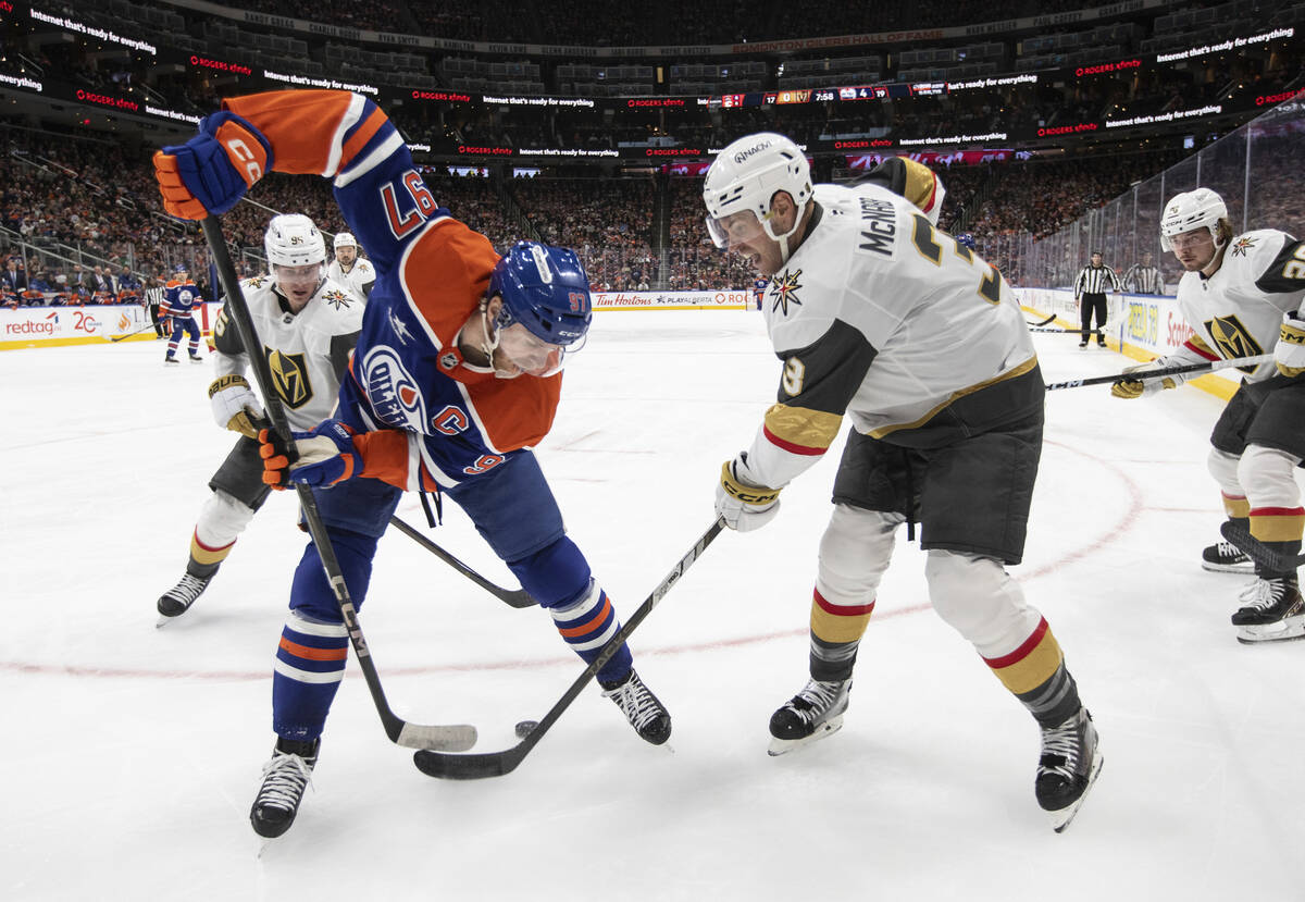 Vegas Golden Knights' Brayden McNabb (3) and Edmonton Oilers' Connor McDavid (97) battle for th ...