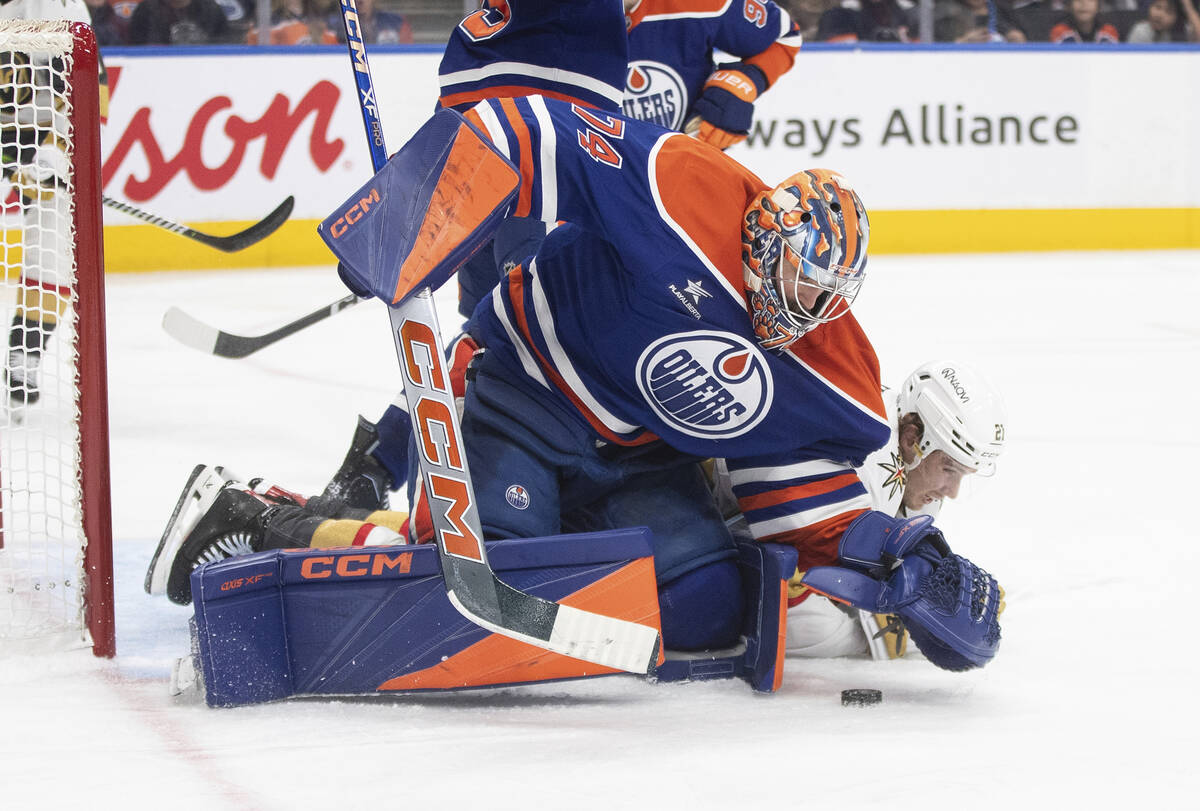 Vegas Golden Knights' Brett Howden (21) tries for the rebound on the save from Edmonton Oilers ...