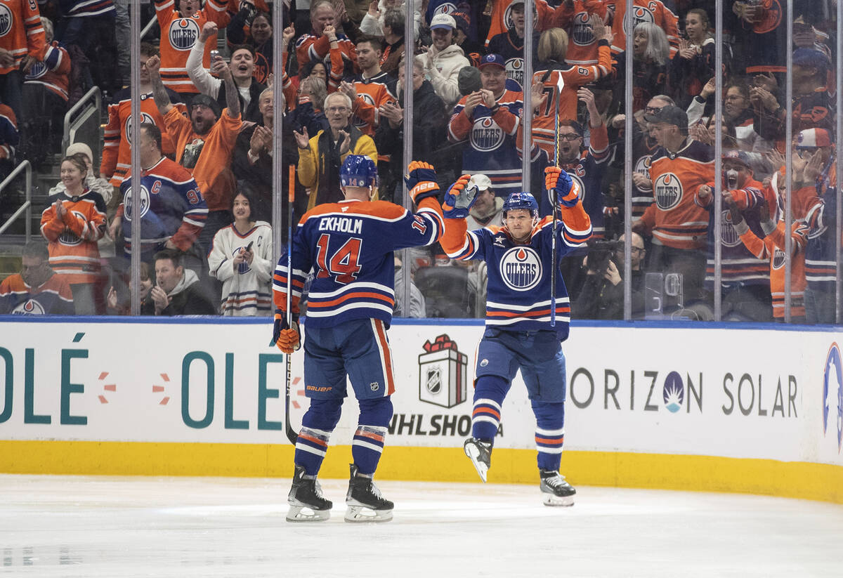 Edmonton Oilers' Mattias Ekholm (14) and Jeff Skinner (53) celebrate a goal against the Vegas G ...