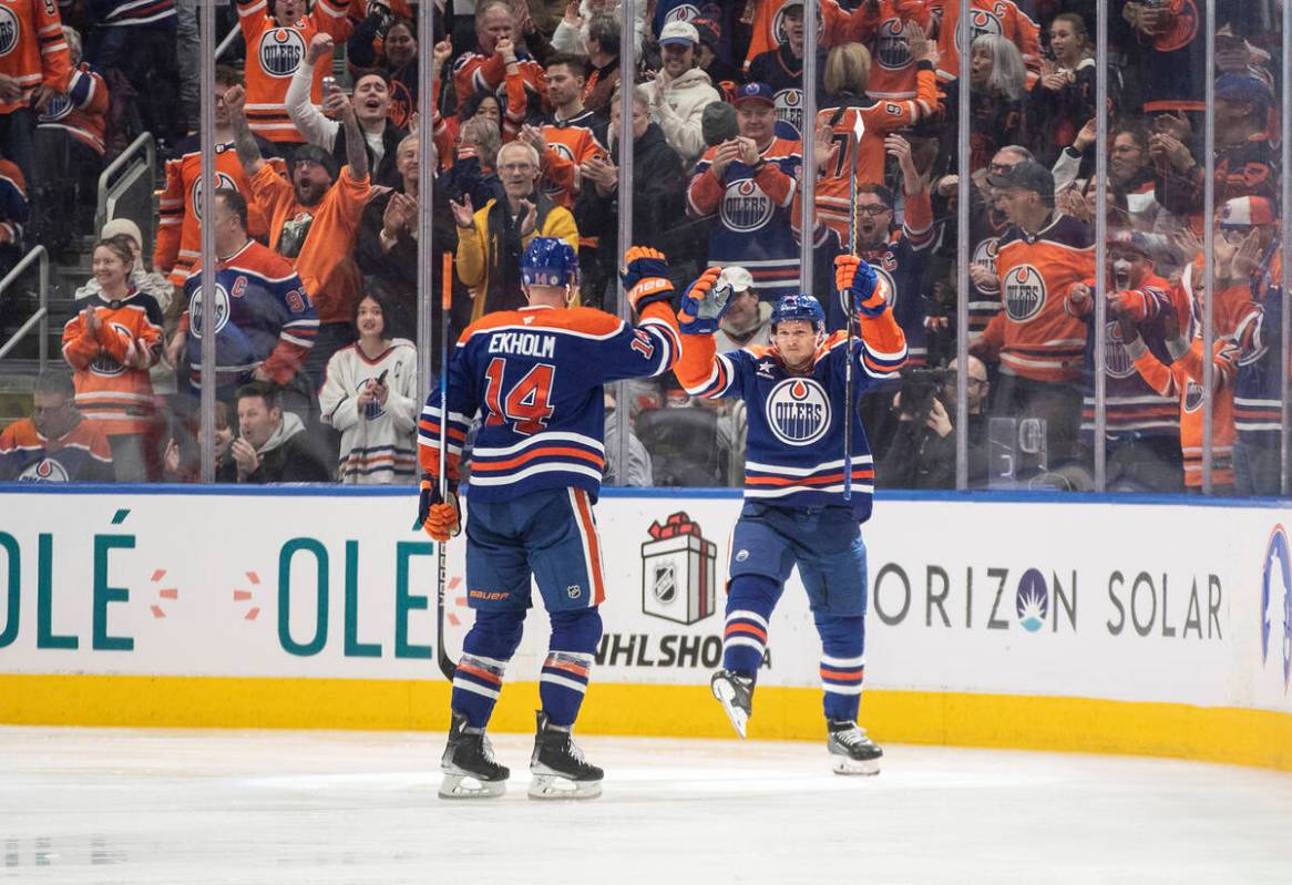 Edmonton Oilers' Mattias Ekholm (14) and Jeff Skinner (53) celebrate a goal against the Vegas G ...