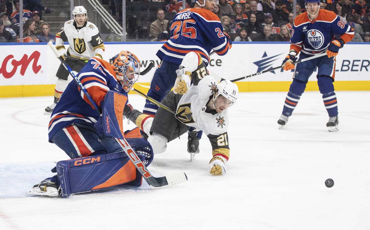 Vegas Golden Knights' Brett Howden (21) tries for the rebound on the save from Edmonton Oilers ...