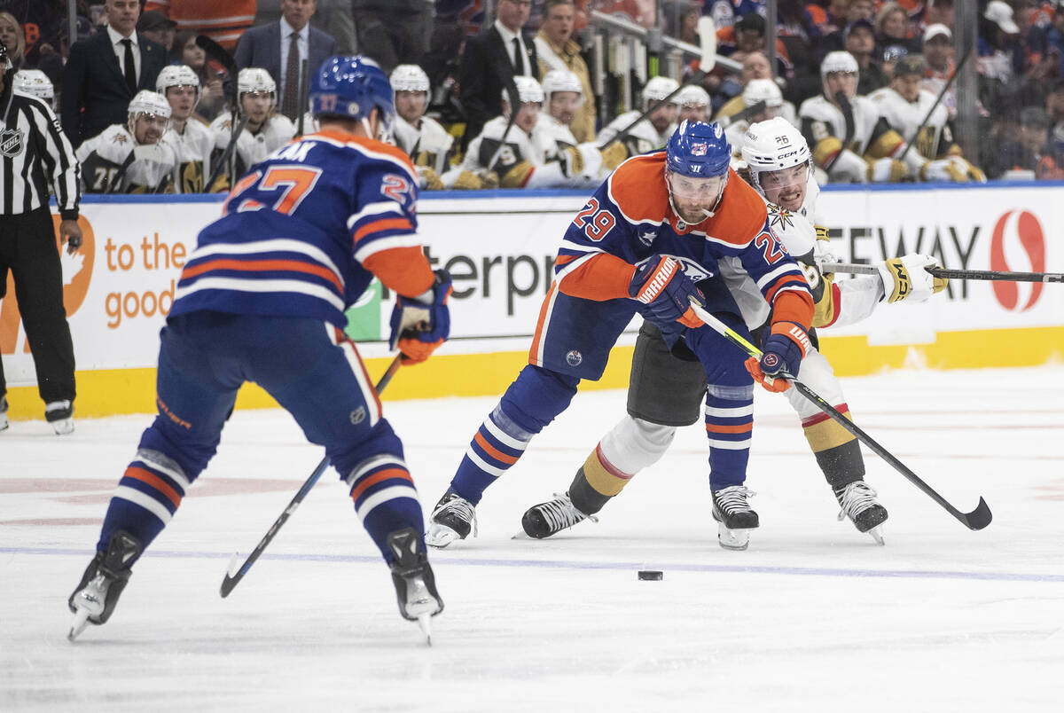 Vegas Golden Knights' Alexander Holtz (26) and Edmonton Oilers' Leon Draisaitl (29) battle for ...