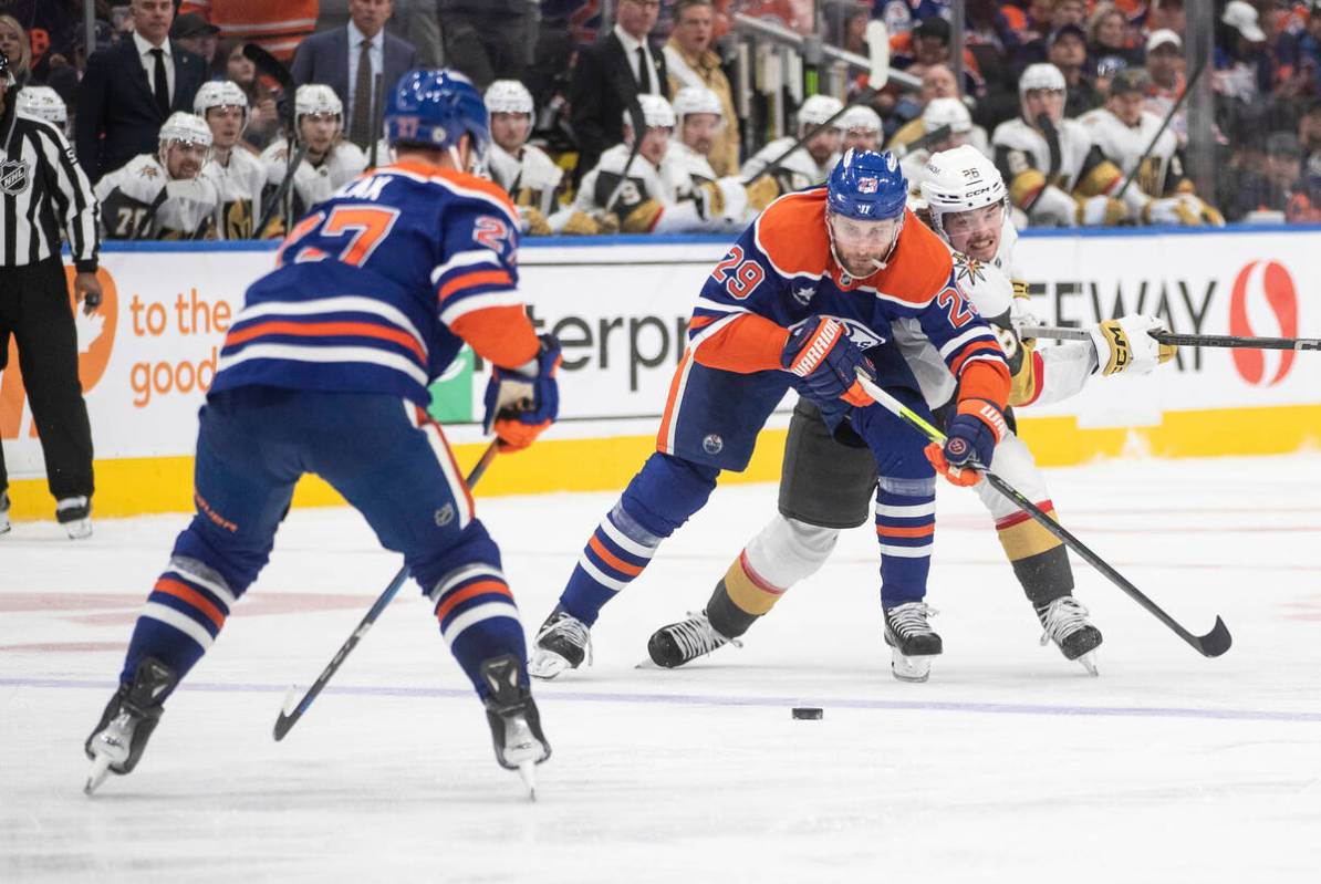 Vegas Golden Knights' Alexander Holtz (26) and Edmonton Oilers' Leon Draisaitl (29) battle for ...