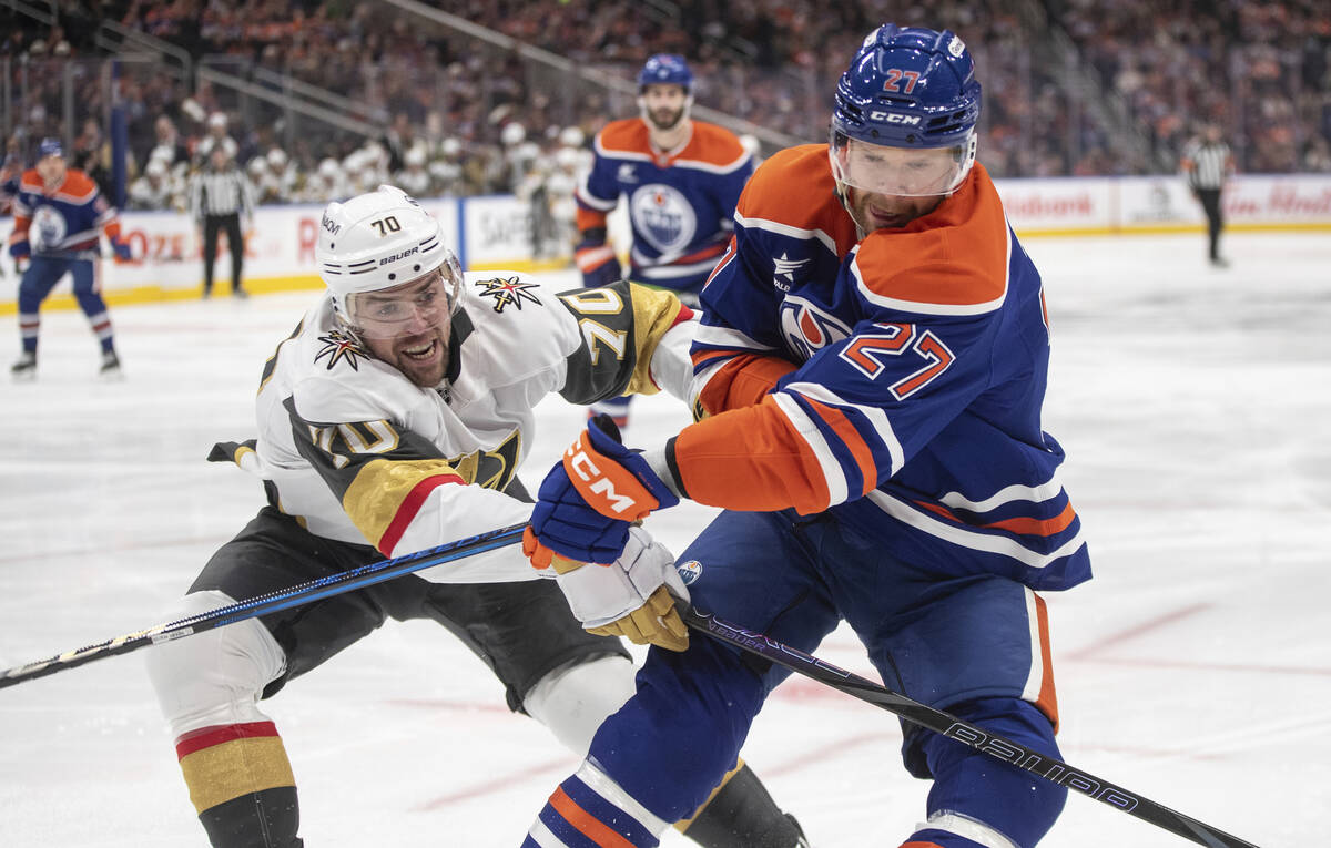 Vegas Golden Knights' Tanner Pearson (70) and Edmonton Oilers' Brett Kulak (27) battle for the ...