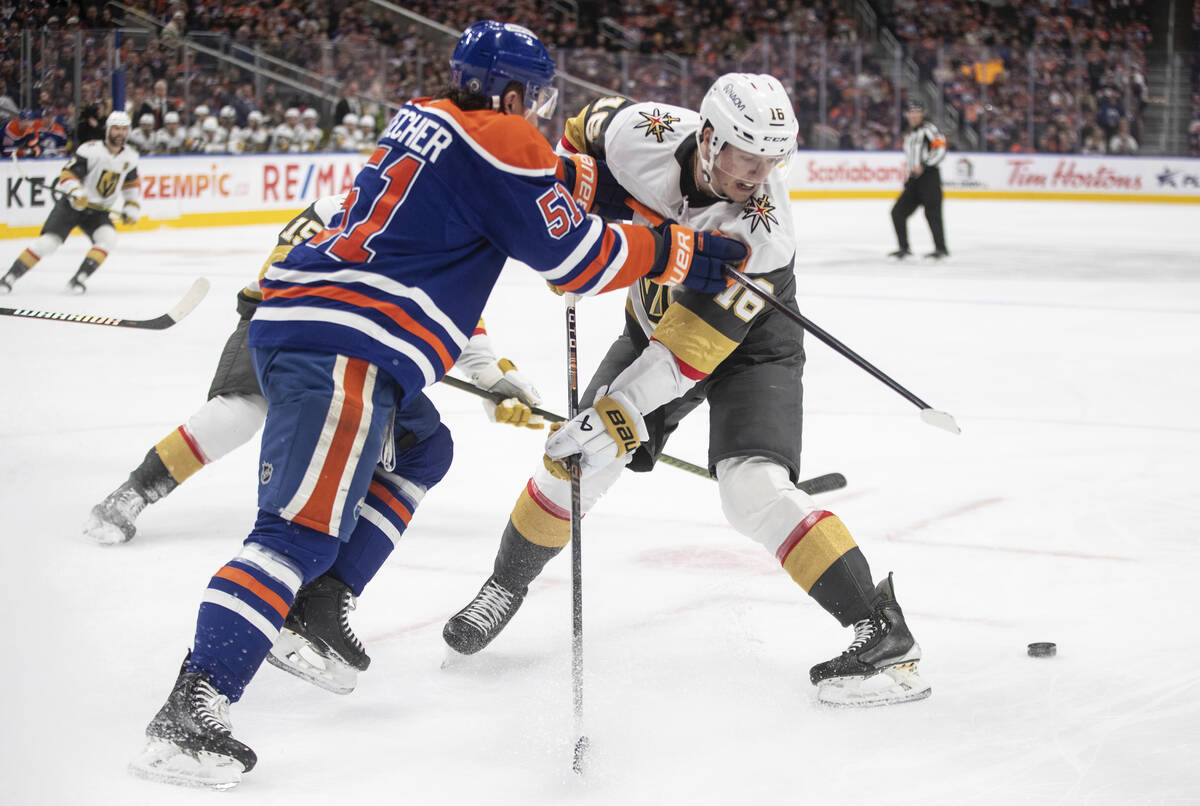 Vegas Golden Knights' Pavel Dorofeyev (16) and Edmonton Oilers' Troy Stecher (51) battle for th ...