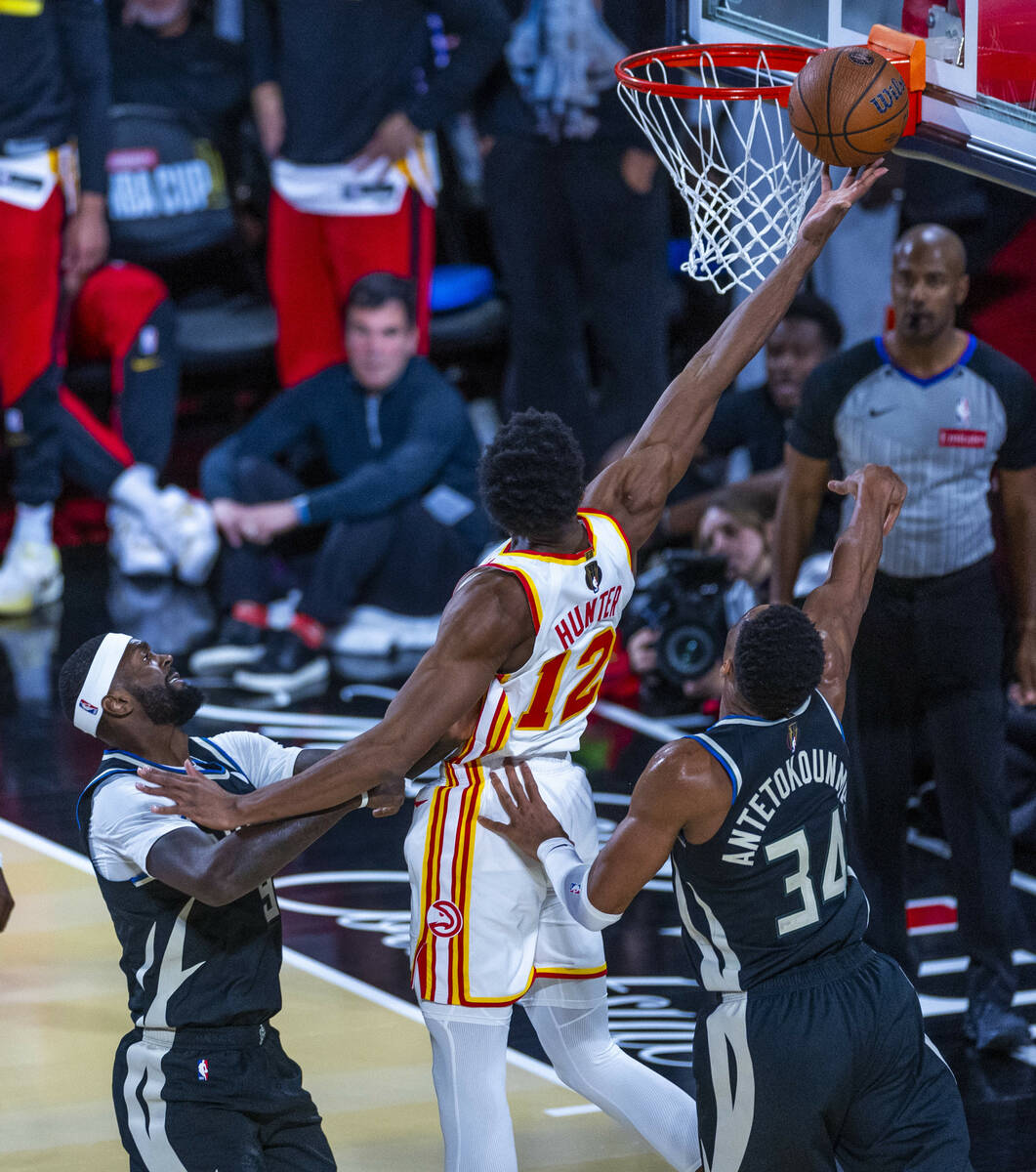 Atlanta Hawks forward De'Andre Hunter (12) gets inside of Milwaukee Bucks forward Bobby Portis ...