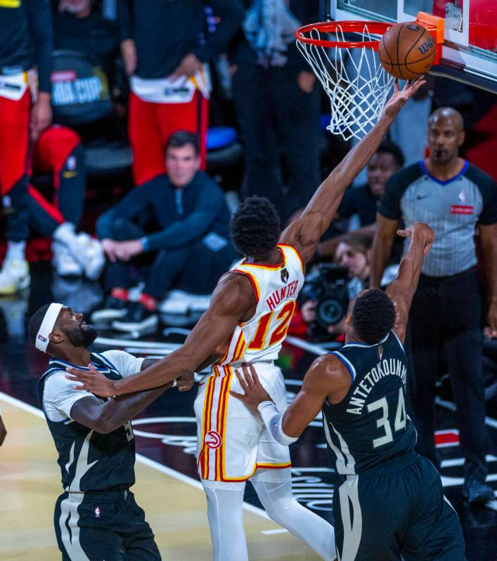 Atlanta Hawks forward De'Andre Hunter (12) gets inside of Milwaukee Bucks forward Bobby Portis ...