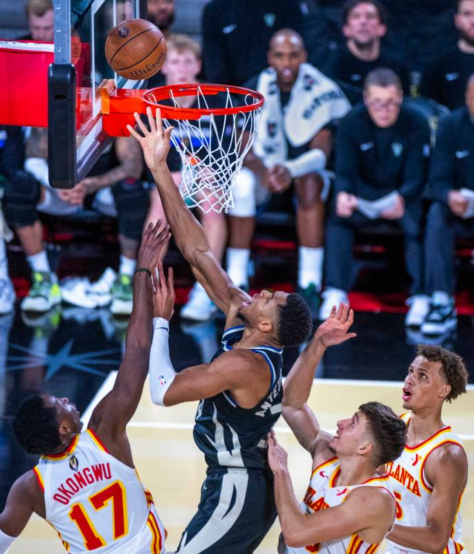 Milwaukee Bucks forward Giannis Antetokounmpo (34) gets to the rim over Atlanta Hawks forward O ...