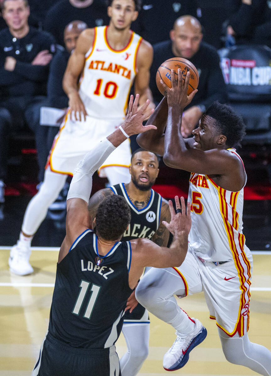 Atlanta Hawks center Clint Capela (15) elevates to the basket past Milwaukee Bucks center Brook ...