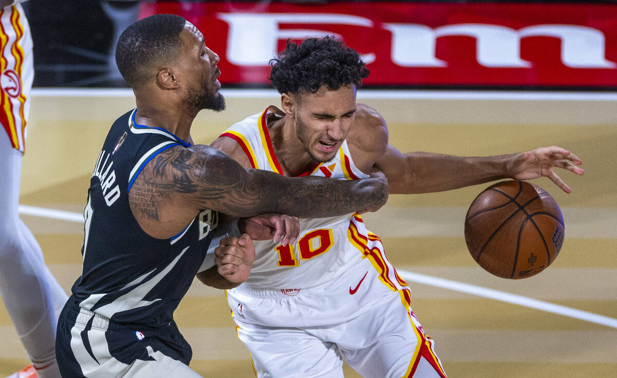 Milwaukee Bucks guard Damian Lillard (0) fouls Atlanta Hawks forward Zaccharie Risacher (10) on ...