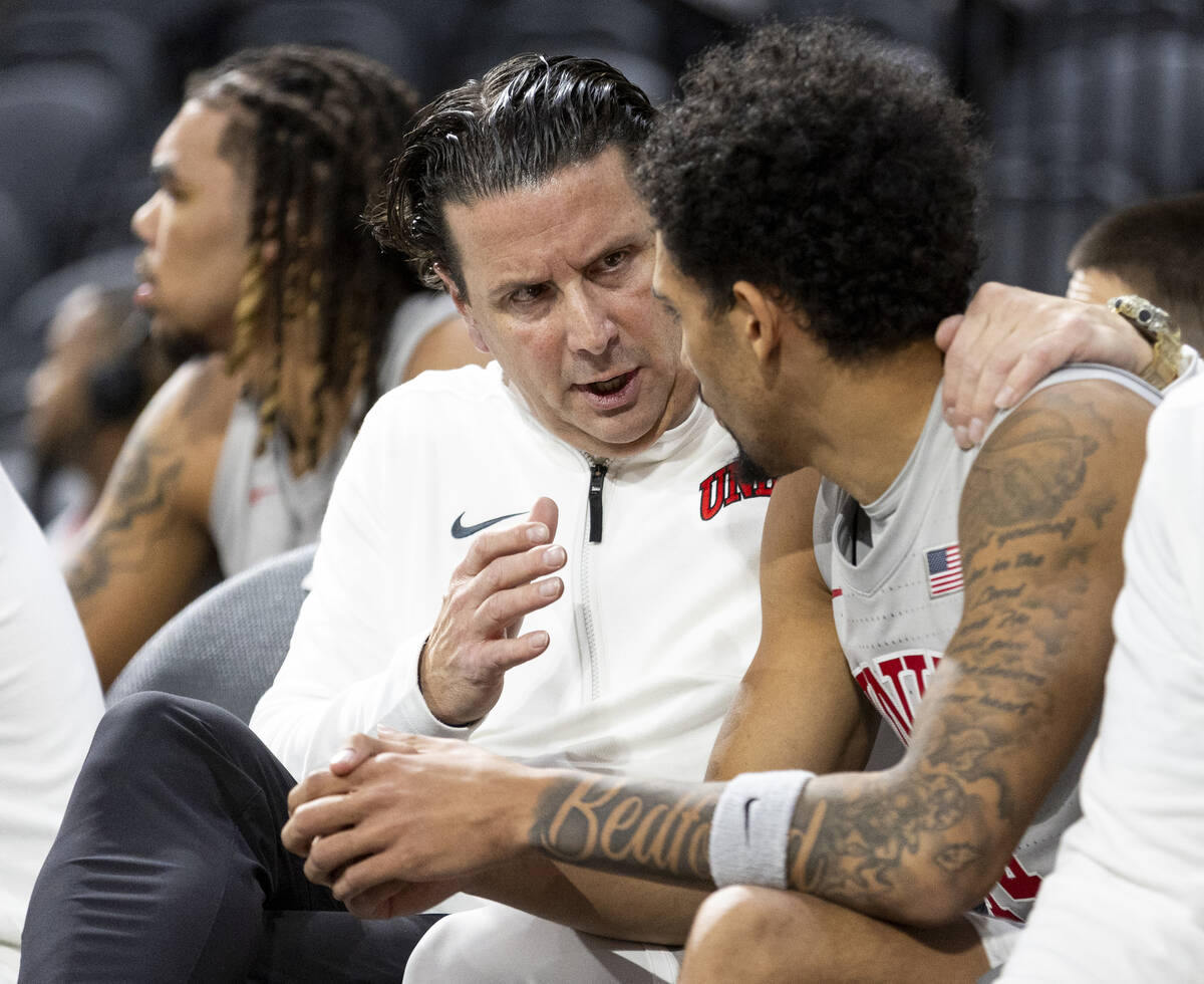 UNLV Assistant Coach Barret Peery, left, talks to UNLV guard Jailen Bedford, right, during the ...