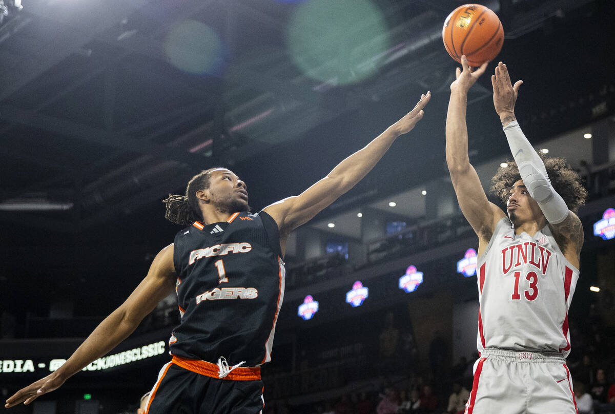 UNLV guard Brooklyn Hicks (13) attempts a three-point shot over Pacific Tigers guard Lamar Wash ...