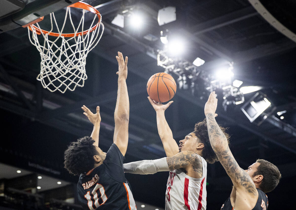 UNLV guard Brooklyn Hicks, center, attempts a layup during the Jack Jones Classic college baske ...