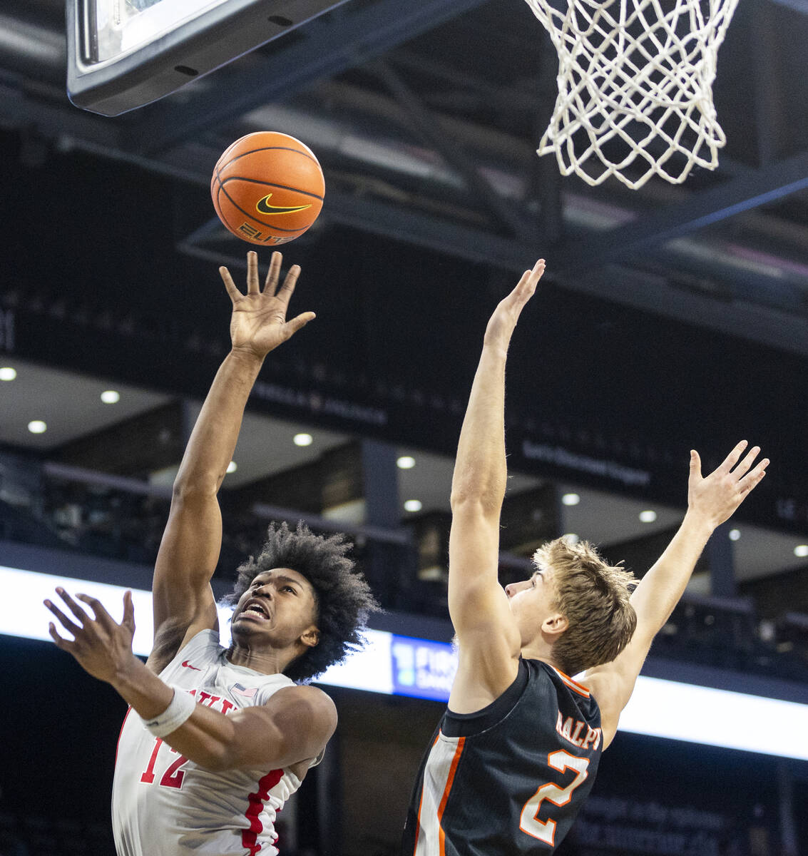 UNLV forward Jacob Bannarbie (12) attempts a shot past Pacific Tigers forward Elias Ralph (2) d ...