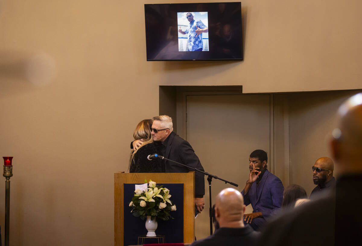 Rachael Gore, left, hugs from Steve Cowan, after talking about her late partner Brandon Durham ...