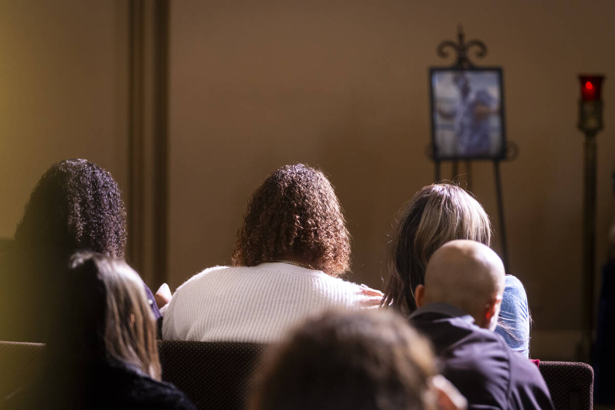 Isabella Durham, center, is comforted during the funeral service for her late father, Brandon D ...