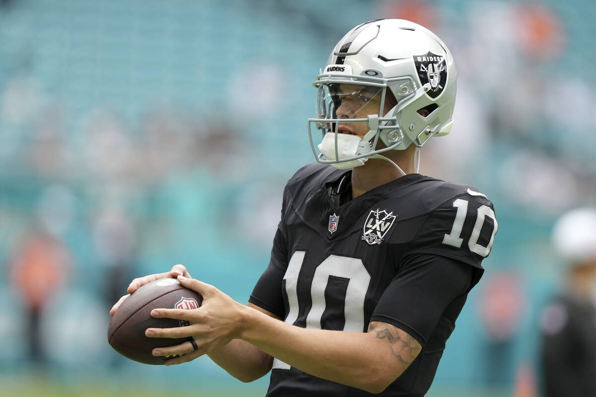 Las Vegas Raiders quarterback Desmond Ridder (10) warms up before an NFL football game, Sunday, ...