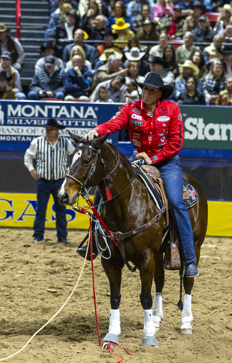 Tie Down Roping contestant Shad Mayfield pats his top event horse Lollipop after a great time d ...