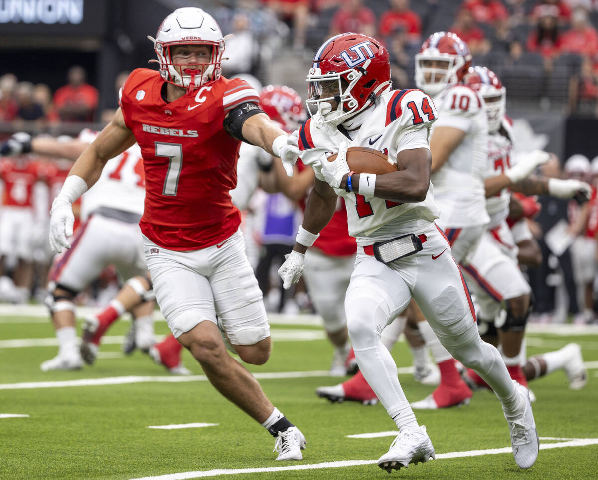 UNLV linebacker Jackson Woodard (7) runs after Utah Tech wide receiver Bryce Parker (14) during ...